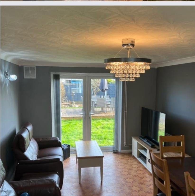 Freshly painted grey living room with French doors onto the garden
