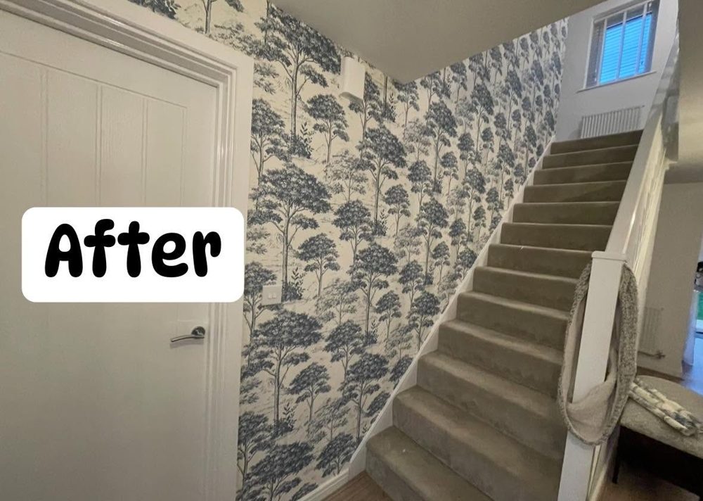 Hallway and stairs after: blue and cream woodland wallpaper up the stairwell